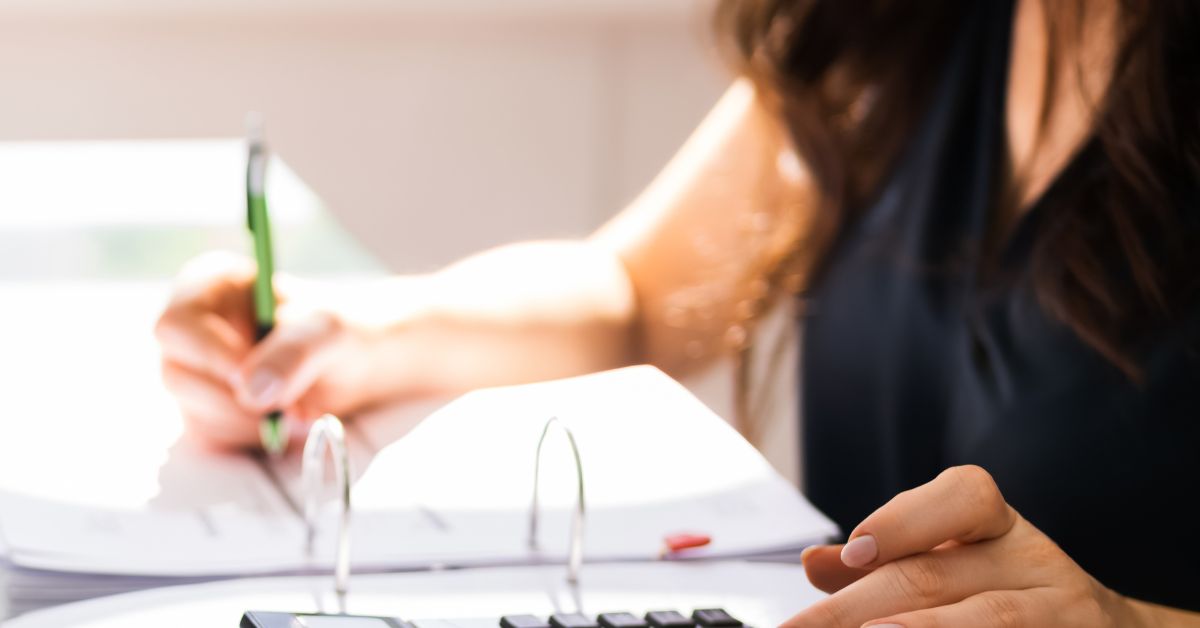 rfp for accounting Woman using a calculator and a binder of information